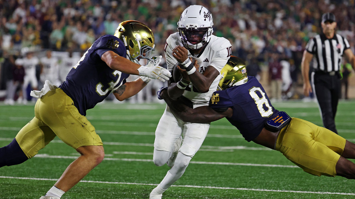 Texas A&M Aggies quarterback Marcel Reed (10) runs the ball as Notre Dame Fighting Irish safety Adon Shuler (8) goes for a tackle during the second half at Notre Dame Stadium. 