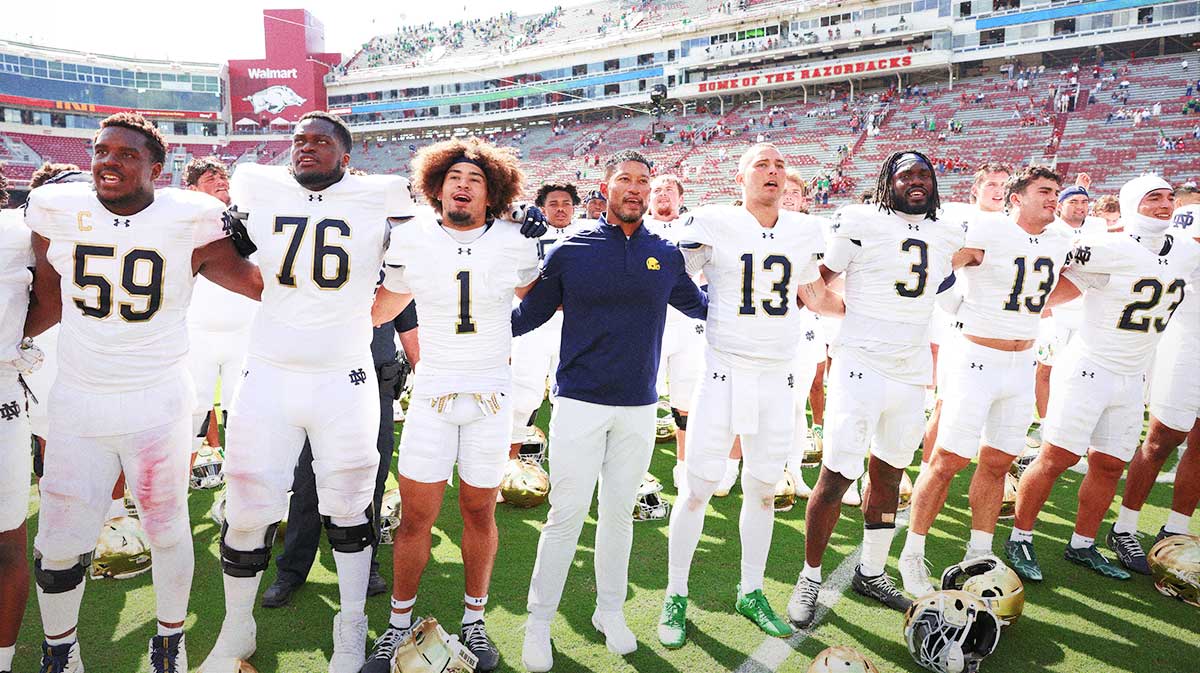 Notre Dame Fighting Irish head coach Marcus Freeman leads the team in celebration after the game against the Arkansas Razorbacks at Donald W. Reynolds Razorback Stadium. Notre Dame won 56-13.