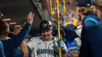 Seattle Mariners catcher Cal Raleigh (29) celebrates in the dugout after hitting a solo home run during the eighth inning against the Colorado Rockies at T-Mobile Park.