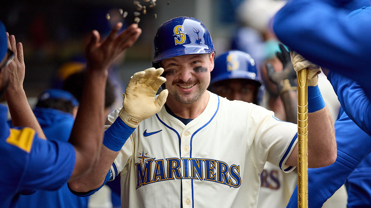 Seattle Mariners catcher Cal Raleigh (29) is greeted in the dugout after hitting a two-run home against the Los Angeles Angels in the first inning at T-Mobile Park.