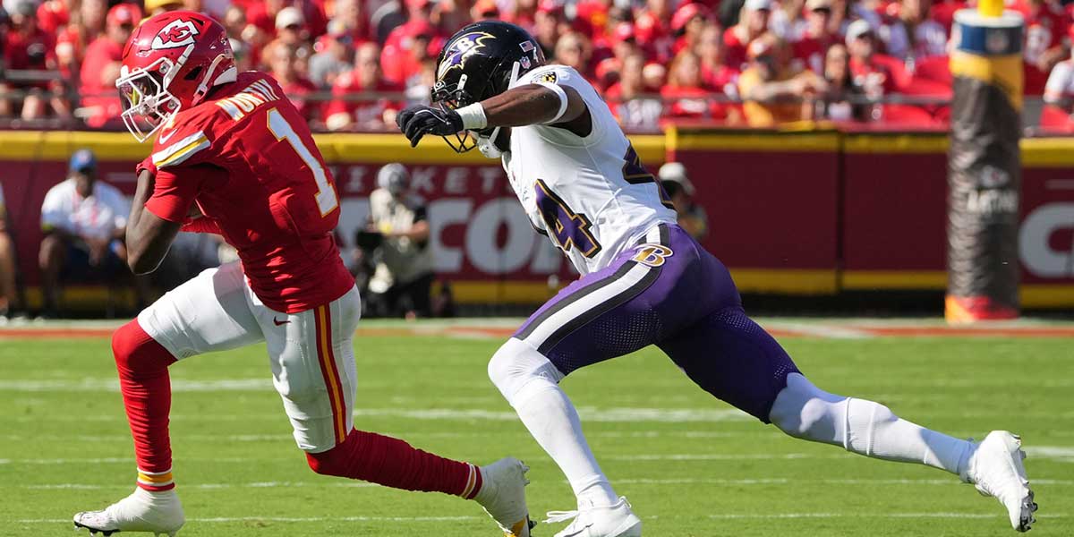 Kansas City Chiefs wide receiver Xavier Worthy (1) runs after making na catch as Baltimore Ravens cornerback Marlon Humphrey (44) defends at GEHA Field at Arrowhead Stadium. Mandatory Credit: Denny Medley-Imagn Images