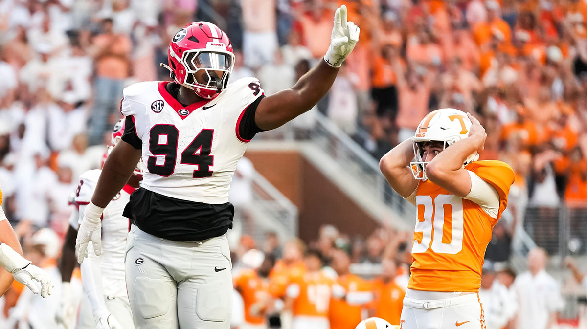 Tennessee kicker Max Gilbert (90) holds his helmet in disbelief as Georgia defensive lineman Xzavier McLeod (94) celebrates Gilbert's missed field goal in the final seconds of a college football game between Tennessee and Georgia at Neyland Stadium.