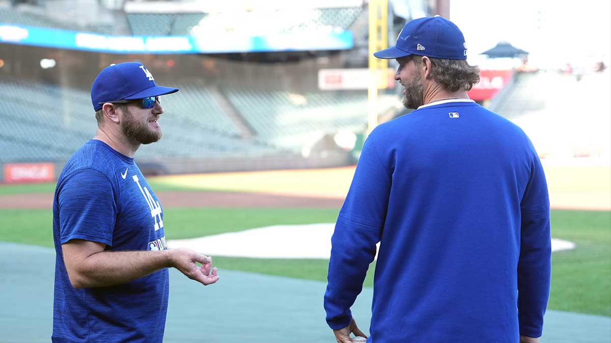 Los Angeles Dodgers third baseman Max Muncy (left) and pitcher Clayton Kershaw (right) talk before the game against the San Francisco Giants at Oracle Park.