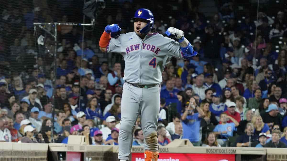 New York Mets catcher Francisco Alvarez (4) gestures to the dugout after hitting a two-run home run against the Chicago Cubs during the eighth inning at Wrigley Field.
