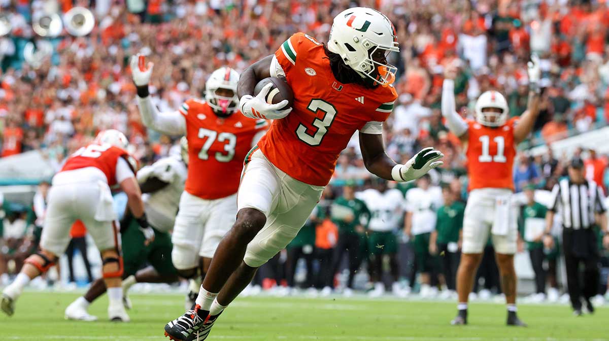 Miami Hurricanes wide receiver Joshua Moore (3) runs into the end zone for a touchdown against the South Florida Bulls in the first quarter at Hard Rock Stadium.
