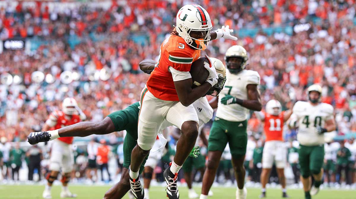 Miami Hurricanes wide receiver Joshua Moore (3) runs into the end zone for a touchdown against the South Florida Bulls in the first quarter at Hard Rock Stadium.