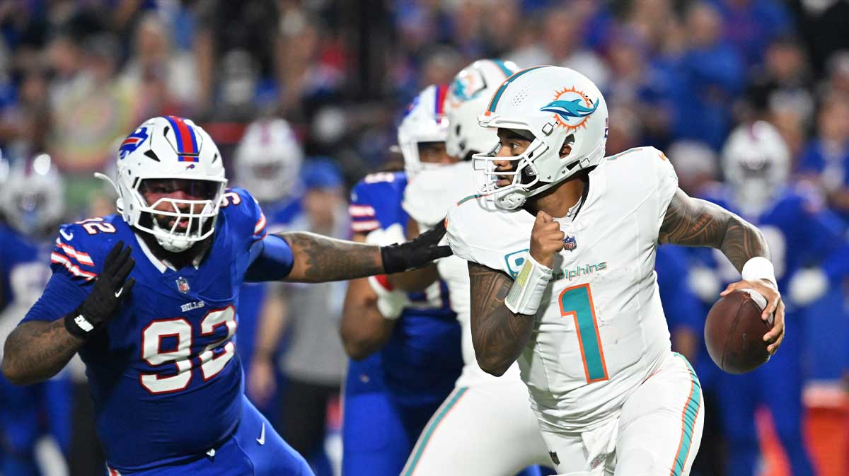 Miami Dolphins quarterback Tua Tagovailoa (1) looks to pass against Buffalo Bills defensive tackle Daquan Jones (92) in the first half at Highmark Stadium.