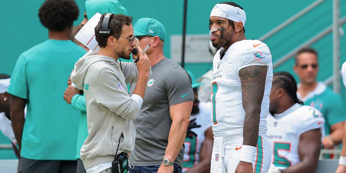 Miami Dolphins head coach Mike McDaniel and quarterback Tua Tagovailoa (1) stand on the sideline against the New England Patriots during the second quarter at Hard Rock Stadium.