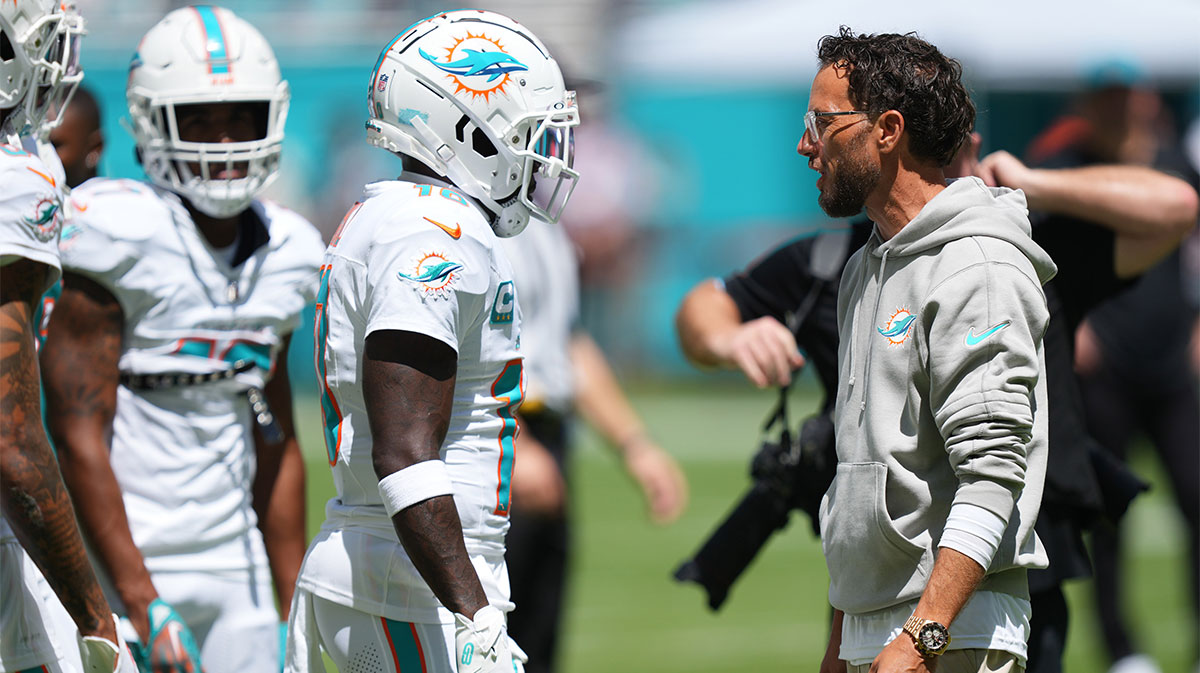 Miami Dolphins head coach Mike McDaniel talks with Miami Dolphins wide receiver Tyreek Hill (10) during pregame warm-ups at Hard Rock Stadium.