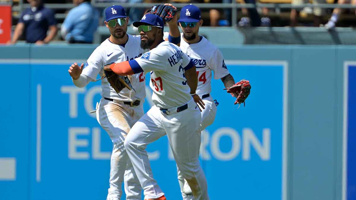 Los Angeles Dodgers left fielder Michael Conforto (23), right fielder Teoscar Hernandez (37) and center fielder Andy Pages (44) head off the field following the final out of the ninth inning defeating the Miami Marlins at Dodger Stadium.