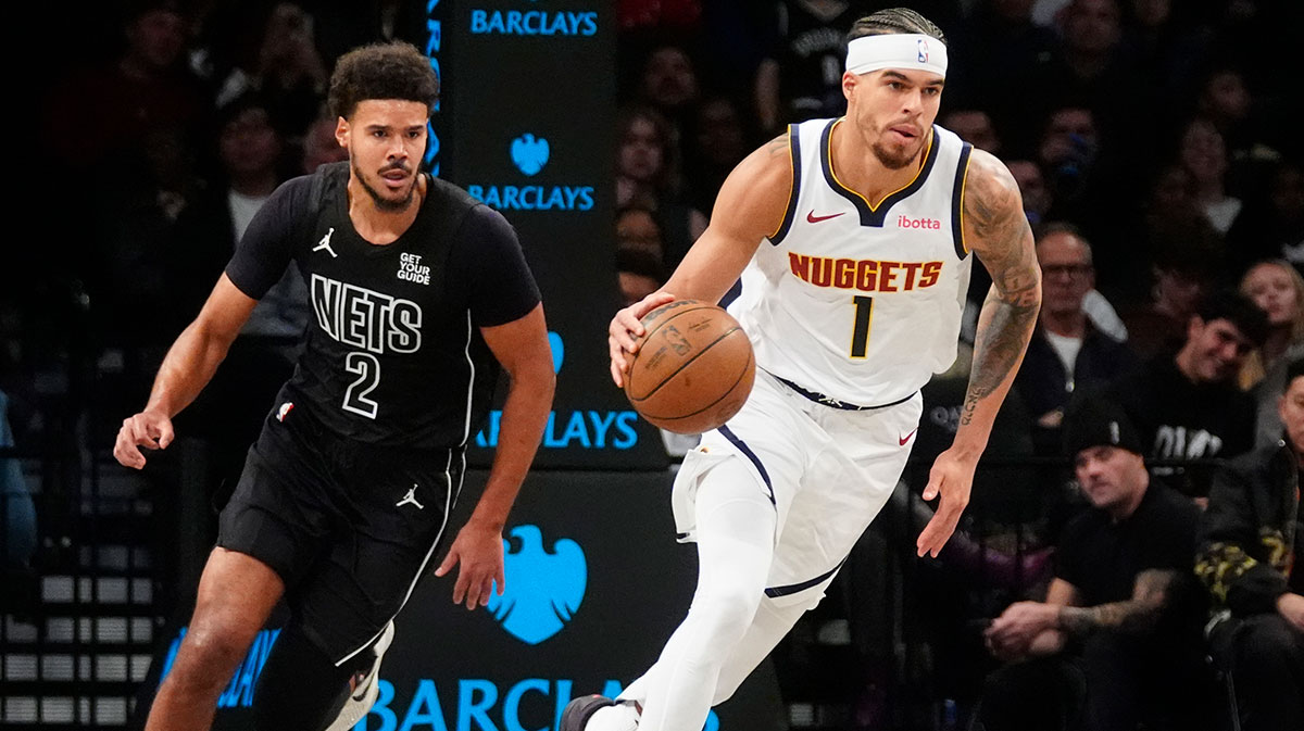 Denver Nuggets small forward Michael Porter Jr. (1) dribbles the ball up the court past Brooklyn Nets small forward Cameron Johnson (2) during the first half at Barclays Center.