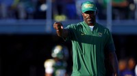 Norfolk State Spartans head coach Michael Vick watches his team warm up before the game against the Towson Tigers