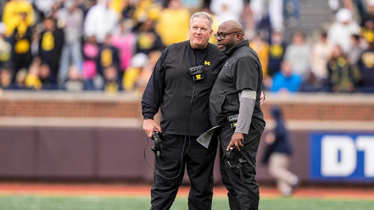 Michigan associate head coach Biff Poggi, left, talks to running backs coach Tony Alford during the second half of the spring game at Michigan Stadium in Ann Arbor on Saturday, April 19, 2025.