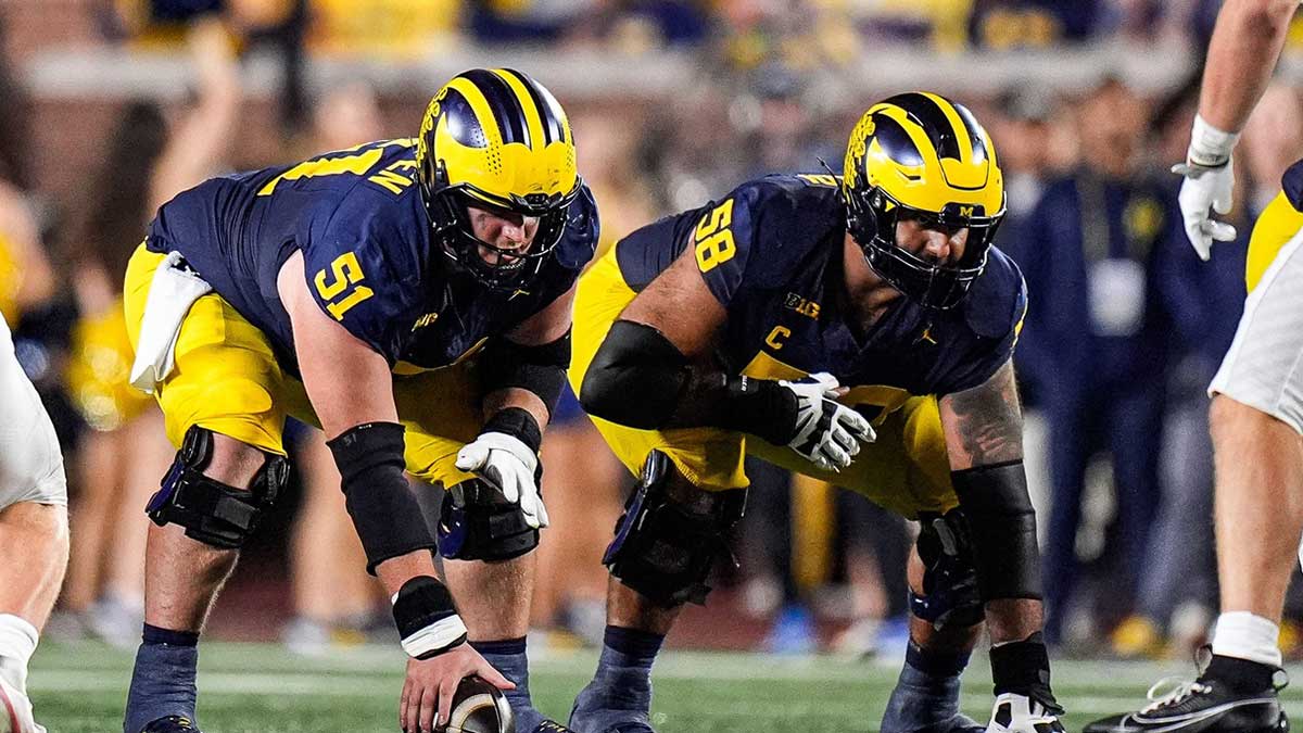 Michigan offensive lineman Greg Crippen (51), center, and offensive lineman Giovanni El-Hadi (58) get ready for a snap against New Mexico during the second half at Michigan Stadium