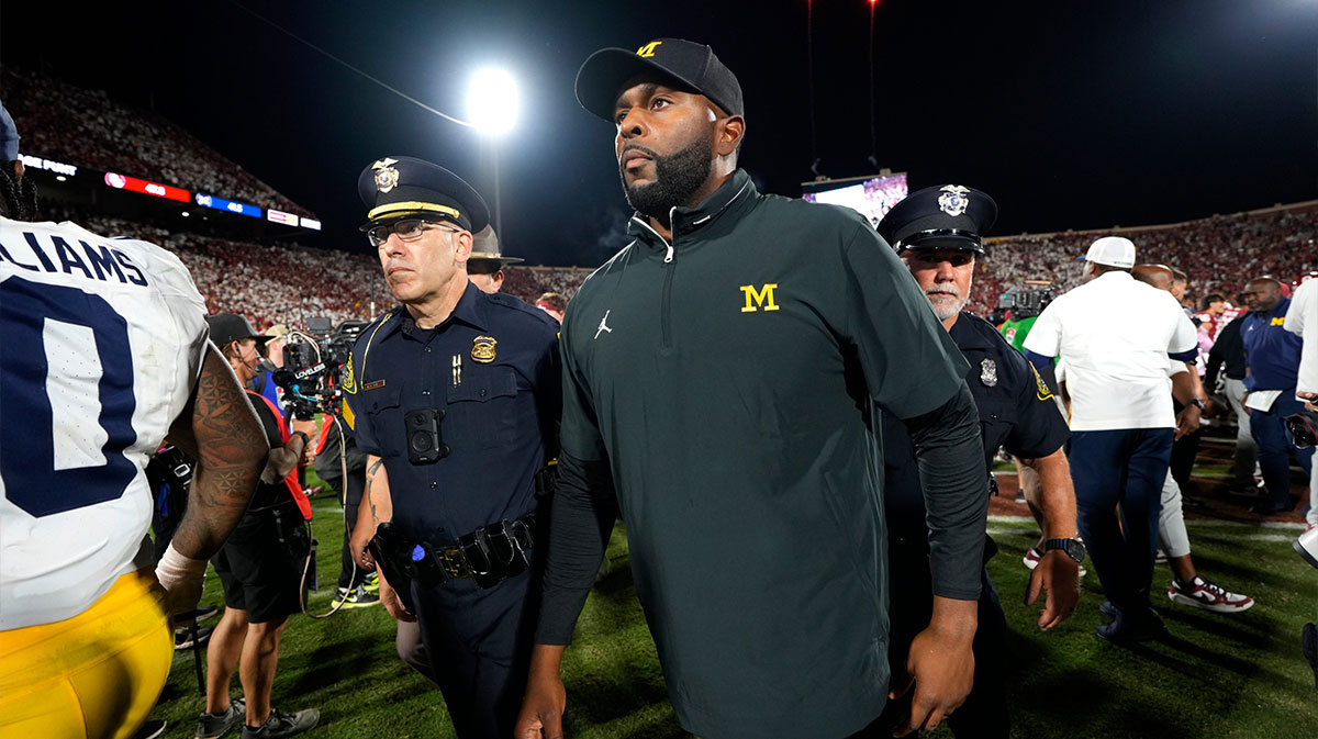Michigan coach Sherrone Moore leaves the field after a college football game between the University of Oklahoma Sooners (OU) and the University of Michigan Wolverines.