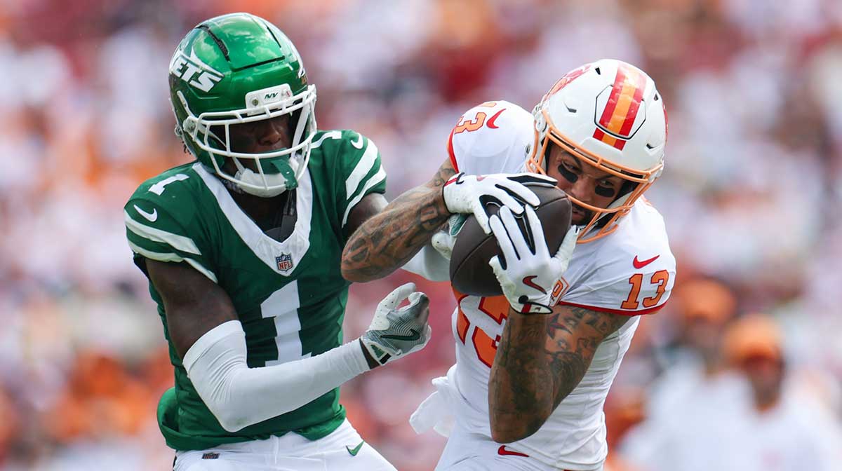 Tampa Bay Buccaneers wide receiver Mike Evans (13) catches pass defended boy New York Jets cornerback Sauce Gardner (1) in the third quarter at Raymond James Stadium.