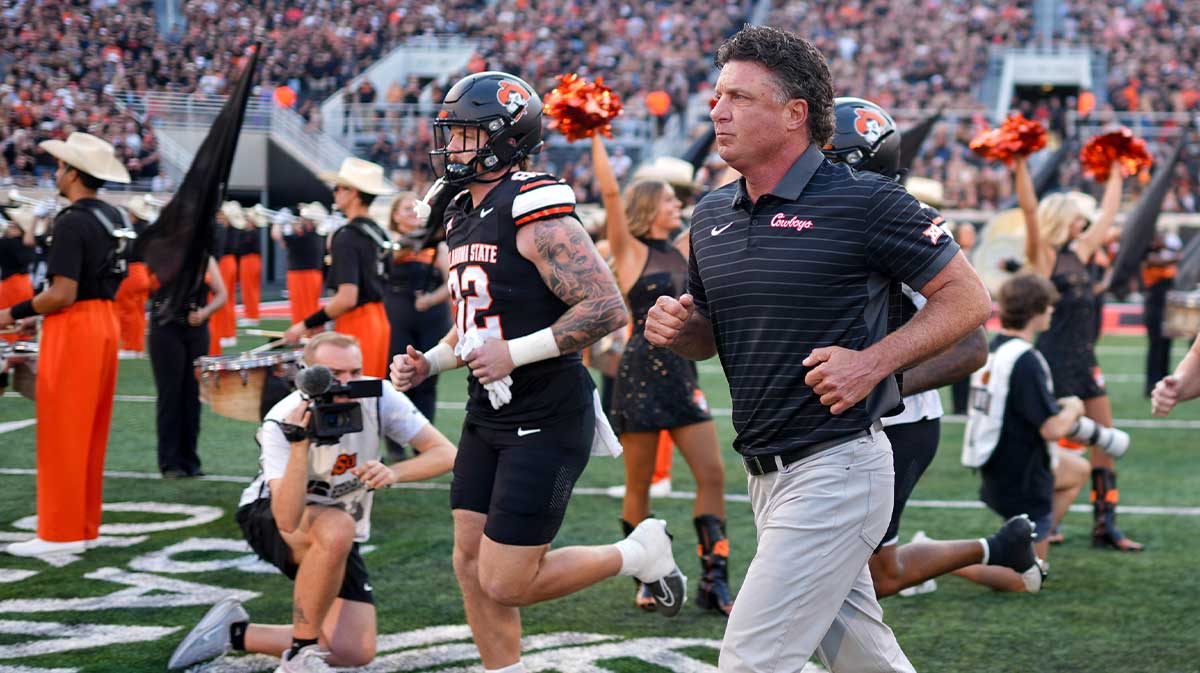 Oklahoma State head coach Mike Gundy runs on the field before an NCAA football game between Oklahoma State (OSU) and Tulsa at Boone Pickens Stadium in Stillwater, Okla., on Friday, Sept. 19, 2025.