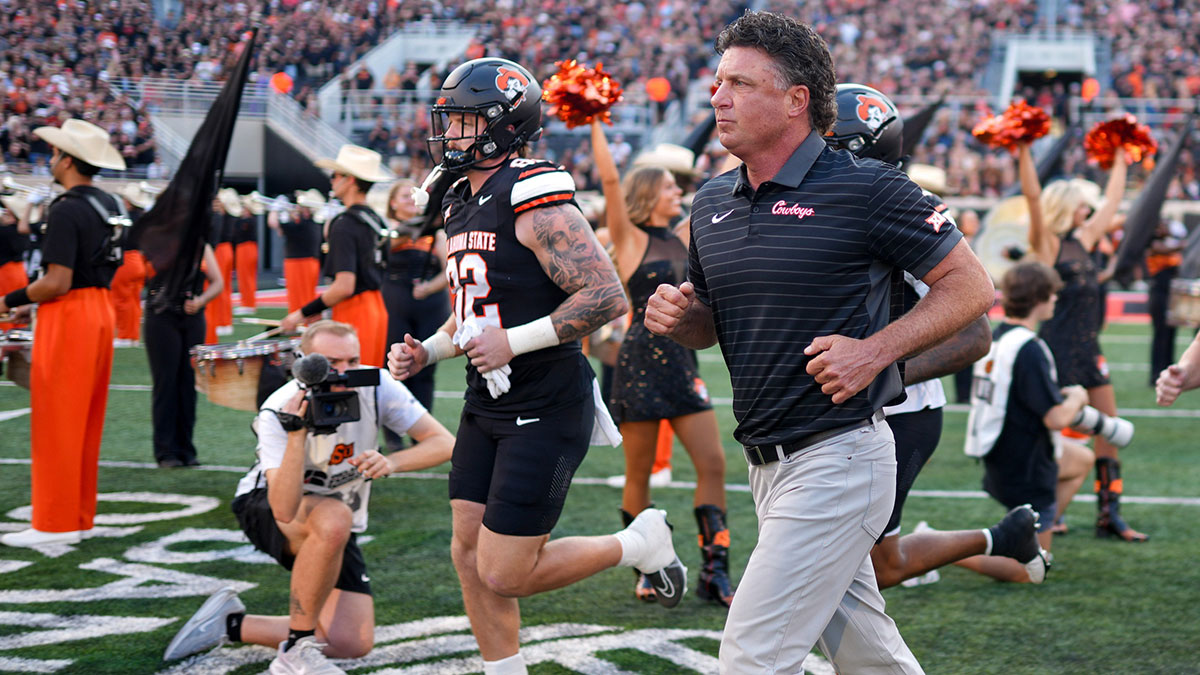 Oklahoma State head coach Mike Gundy runs on the field before an NCAA football game between Oklahoma State (OSU) and Tulsa at Boone Pickens Stadium in Stillwater, Okla., on Friday, Sept. 19, 2025.