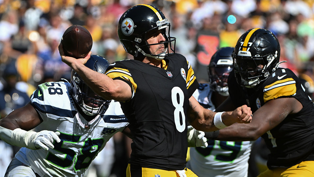 Pittsburgh Steelers quarterback Aaron Rodgers (8) throws a pass while being pressured by Seattle Seahawks linebacker Derick Hall (58) during the second half at Acrisure Stadium.