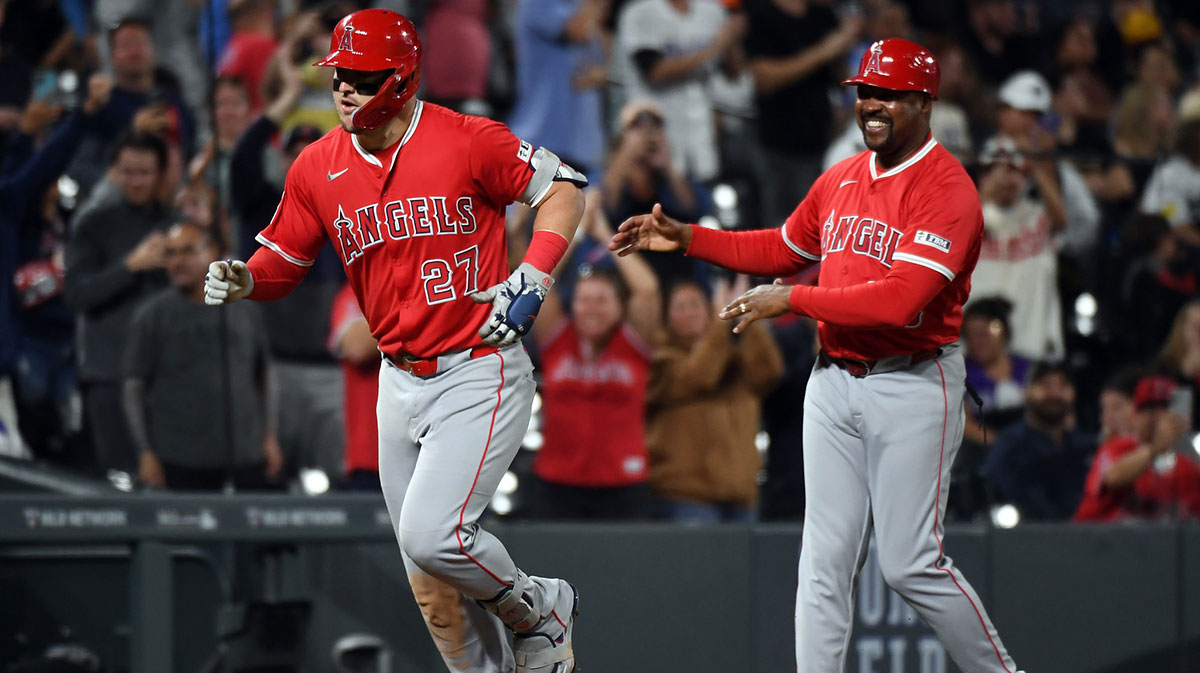 Los Angeles Angels designated hitter Mike Trout (27) is congratulated by third base coach Bo Porter (88) after hitting his 400th career home run during the eighth inning against the Colorado Rockies after at Coors Field.