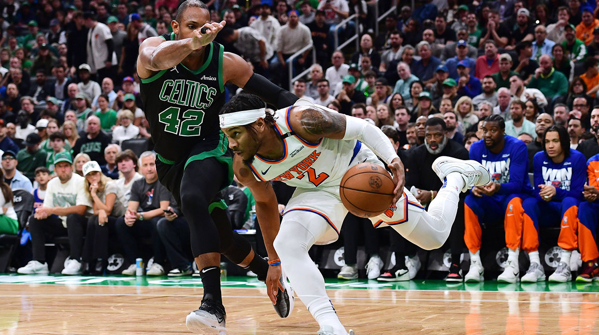 New York Knicks guard Miles McBride (2) controls the ball while Boston Celtics center Al Horford (42) defends in the first half during game five of the second round for the 2025 NBA Playoffs at TD Garden.