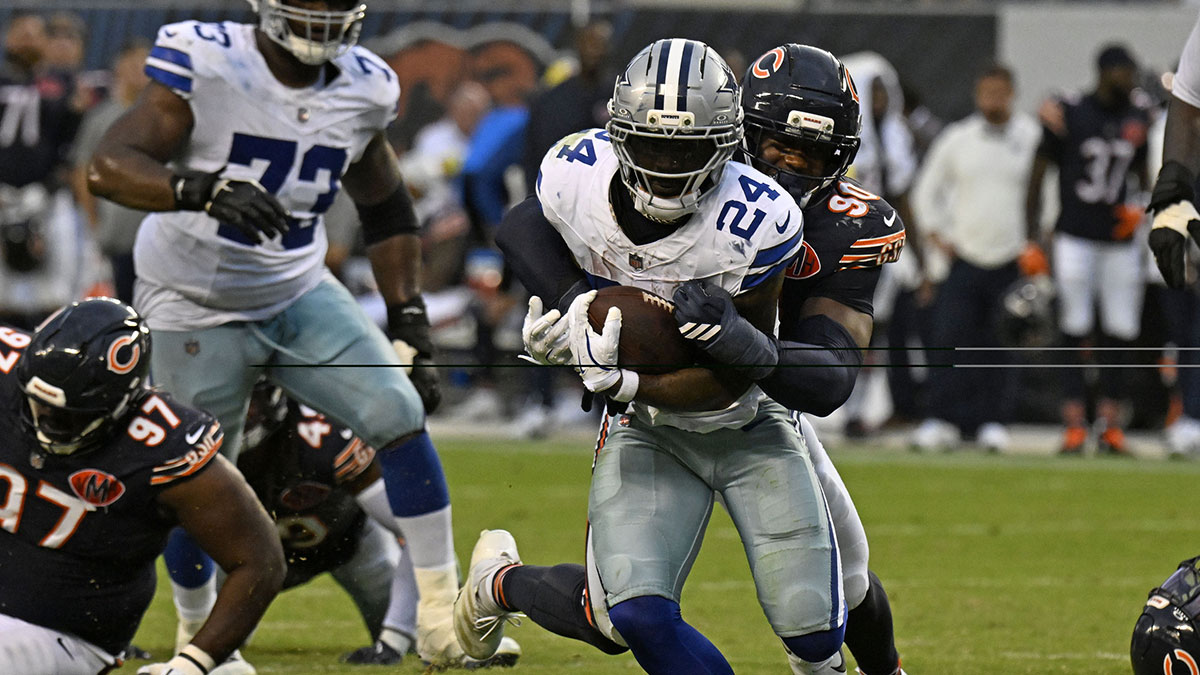 Dallas Cowboys running back Miles Sanders (24) rushes the ball against Chicago Bears defensive end Dominique Robinson (90) during the second half at Soldier Field.