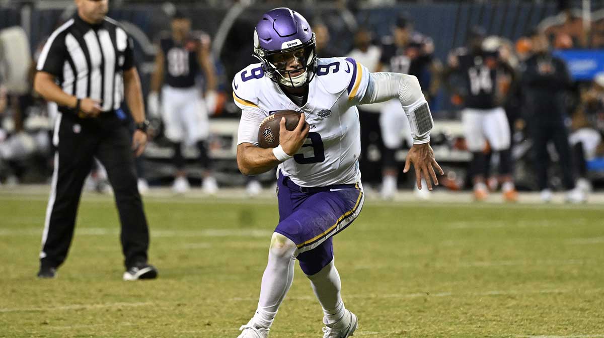 Minnesota Vikings quarterback J.J. McCarthy (9) rushes the ball against the Chicago Bears during the second half at Soldier Field.