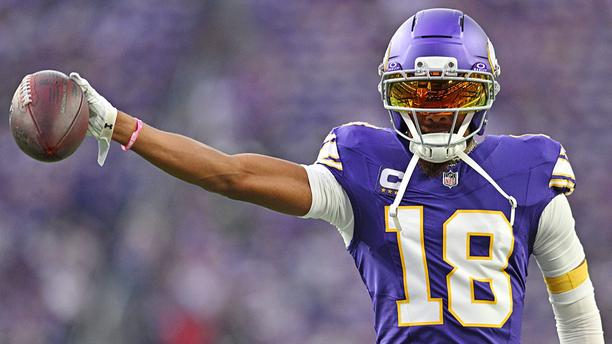 Minnesota Vikings wide receiver Justin Jefferson (18) holds out the ball before the game against the Atlanta Falcons at U.S. Bank Stadium.