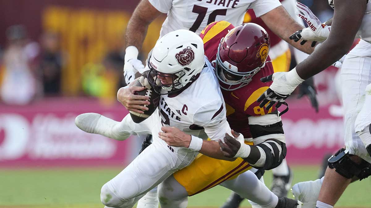 Missouri State Bears quarterback Jacob Clark (12) is sacked by Southern California Trojans defensive tackle Jide Abasiri (97) in the second half at United Airlines Field at Los Angeles Memorial Coliseum.