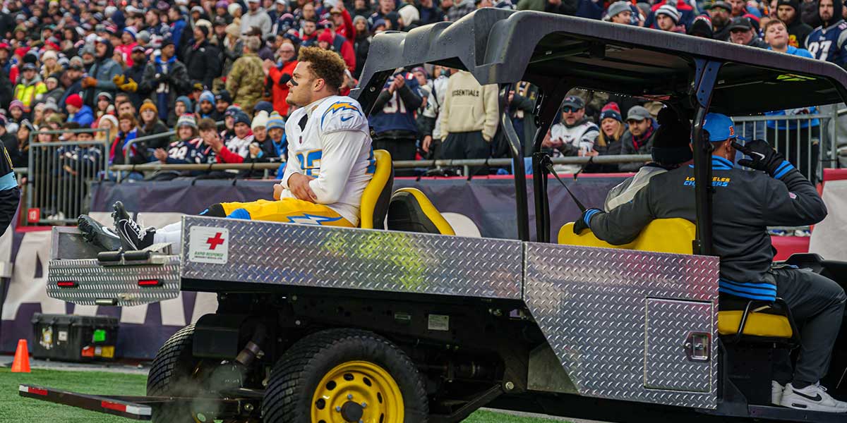 Los Angeles Chargers cornerback Elijah Molden (22) is carted off the field after an injury as they take on the New England Patriots in the second half at Gillette Stadium.
