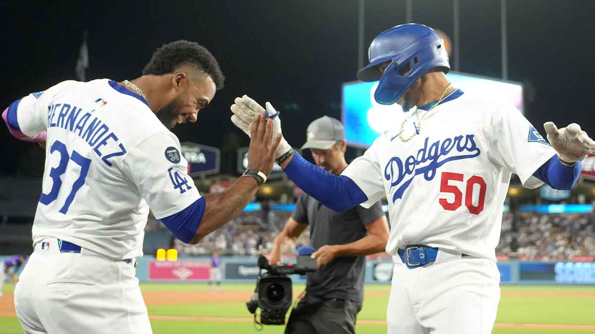 Los Angeles Dodgers shortstop Mookie Betts (50) celebrates with right fielder Teoscar Hernandez (37) after hitting a home run in the third inning against the Colorado Rockies at Dodger Stadium.