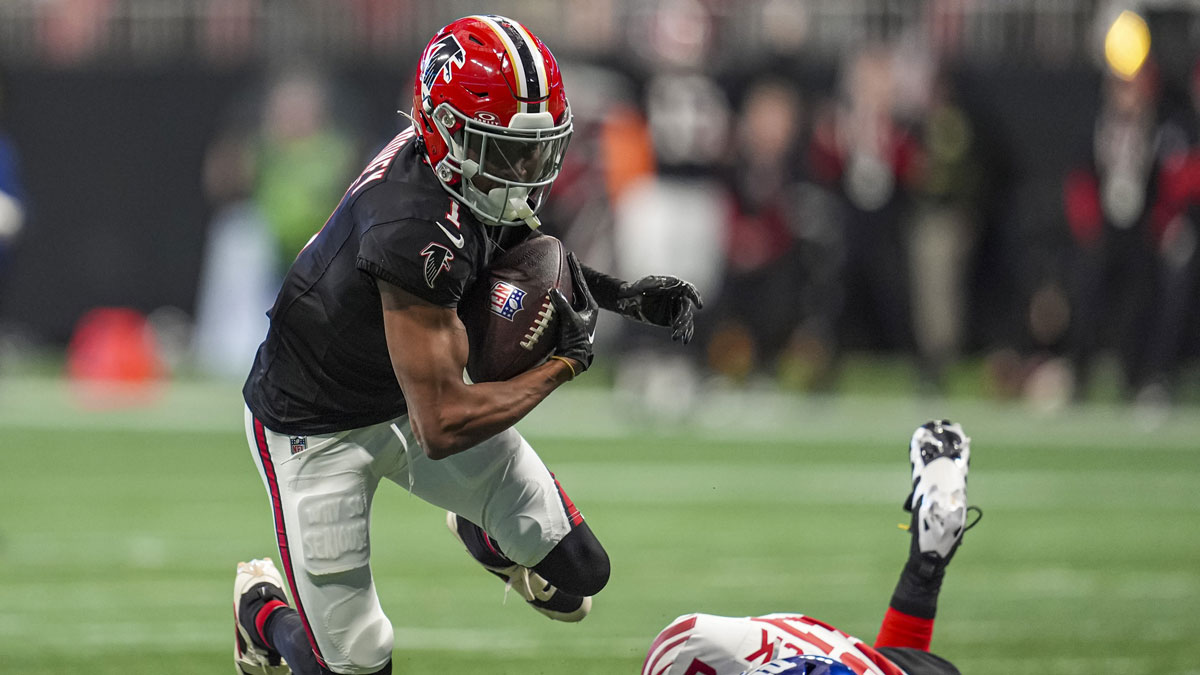 Atlanta Falcons wide receiver Darnell Mooney (1) flies over a tackle by New York Giants safety Jason Pinnock (27) at Mercedes-Benz Stadium.