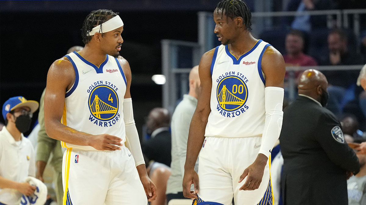 Golden State Warriors guard Moses Moody (4) and forward Jonathan Kuminga (00) talk during the second quarter against the LA Clippers at Chase Center.