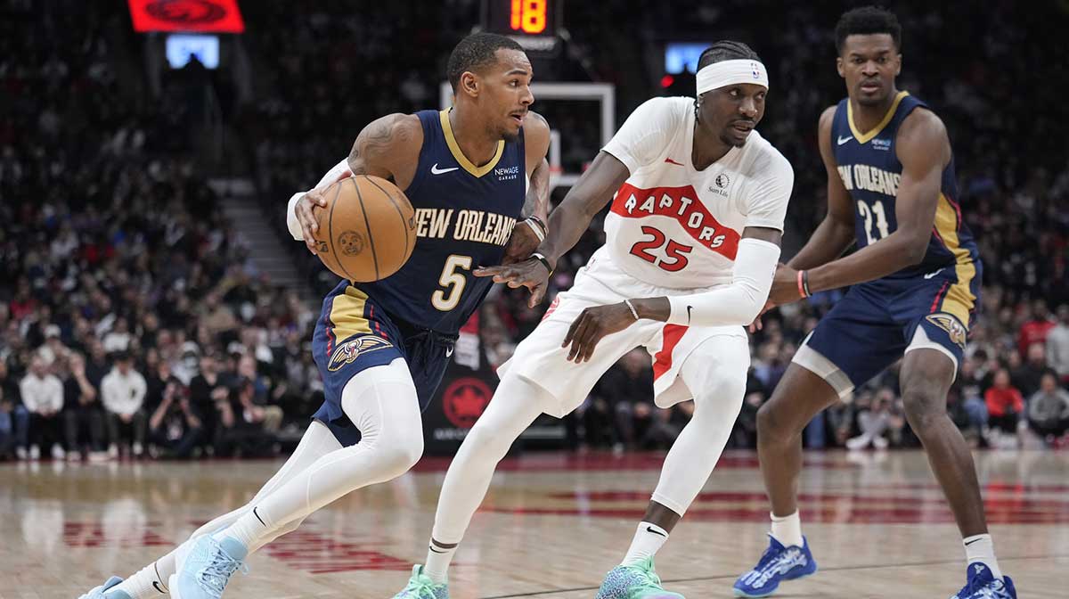 New Orleans Pelicans guard Dejounte Murray (5) controls the ball as Toronto Raptors forward Chris Boucher (25) defends during the second half at Scotiabank Arena.