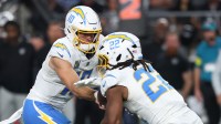Los Angeles Chargers quarterback Justin Herbert (10) hands the ball off to Los Angeles Chargers running back Najee Harris (22) at Allegiant Stadium