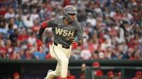 Washington Nationals second baseman Darren Baker (10) runs to first base after hitting a single against the Philadelphia Phillies during the ninth inning at Nationals Park.