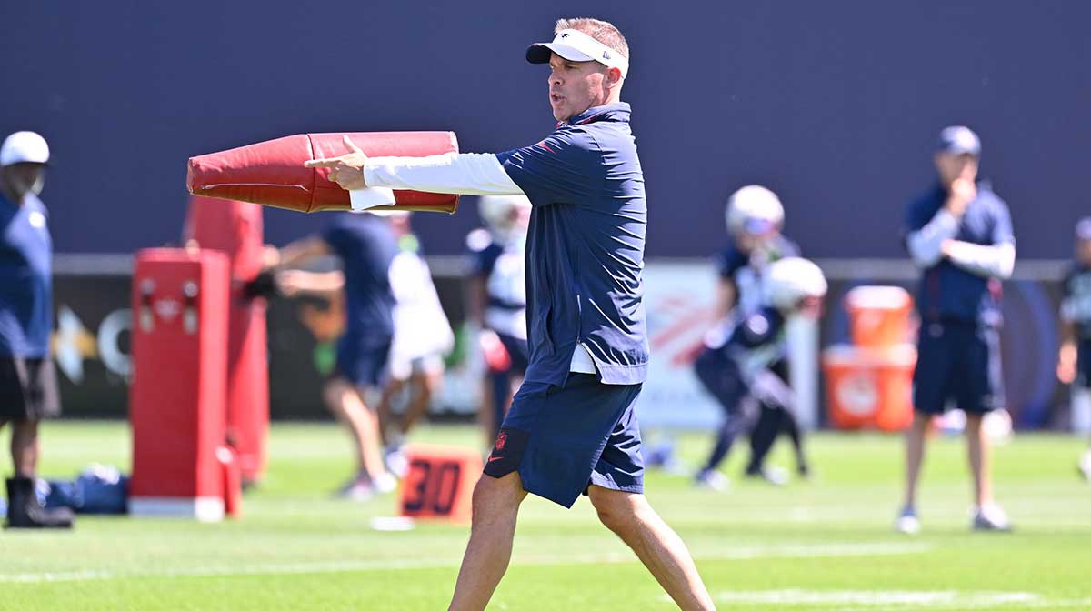 New England Patriots offensive coordinator Josh McDaniels works with the team during training camp at Gillette Stadium.