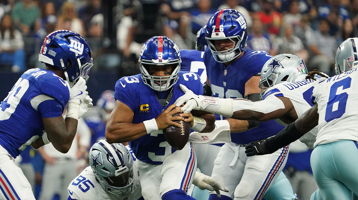 New York Giants quarterback Russell Wilson (3) is pressured by Dallas Cowboys defensive tackle Osa Odighizuwa (97) and defensive tackle Kenny Clark (95) at AT&T Stadium.