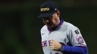 New York Mets manager Carlos Mendoza (64) jogs back to the dugout after a pitching change during the sixth inning against the Philadelphia Phillies at Citizens Bank Park. Mandatory Credit: Bill Streicher-Imagn Images