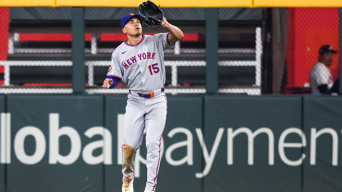 New York Mets center fielder Tyrone Taylor (15) catches a fly ball against the Atlanta Braves in the eighth inning at Truist Park.