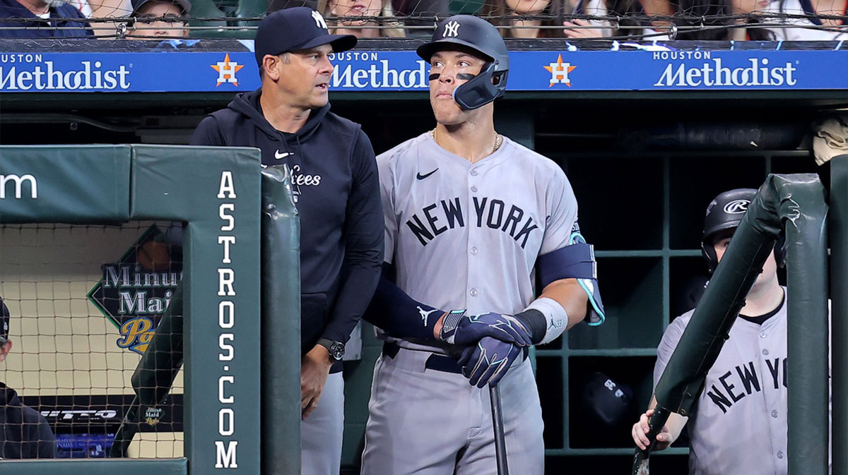 New York Yankees manager Aaron Boone (17) and New York Yankees center fielder Aaron Judge (99) watch the action from the dugout against the Houston Astros during the first inning at Minute Maid Park.