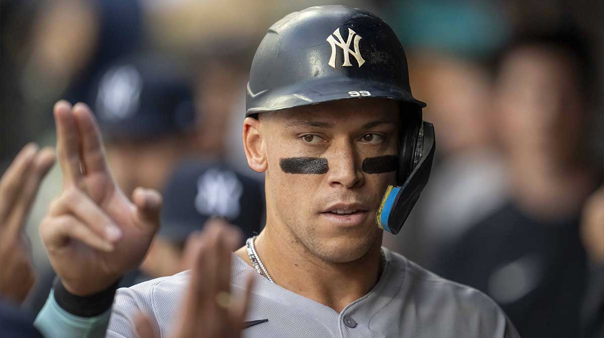 New York Yankees right fielder Aaron Judge (99) celebrates with teammates in the dugout after scoring a run against the Minnesota Twins in the first inning at Target Field.