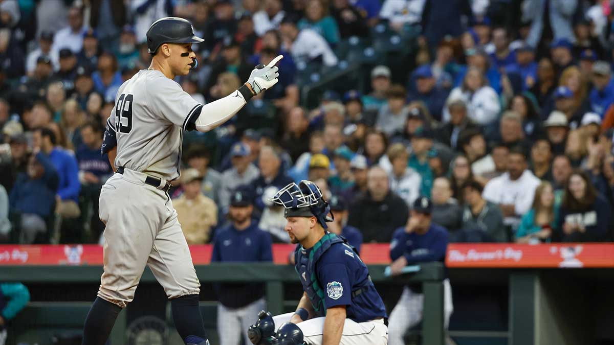 New York Yankees center fielder Aaron Judge (99) celebrates after hitting a solo-home run against the Seattle Mariners during the seventh inning at T-Mobile Park. Seattle Mariners catcher Cal Raleigh (29) kneels at right.