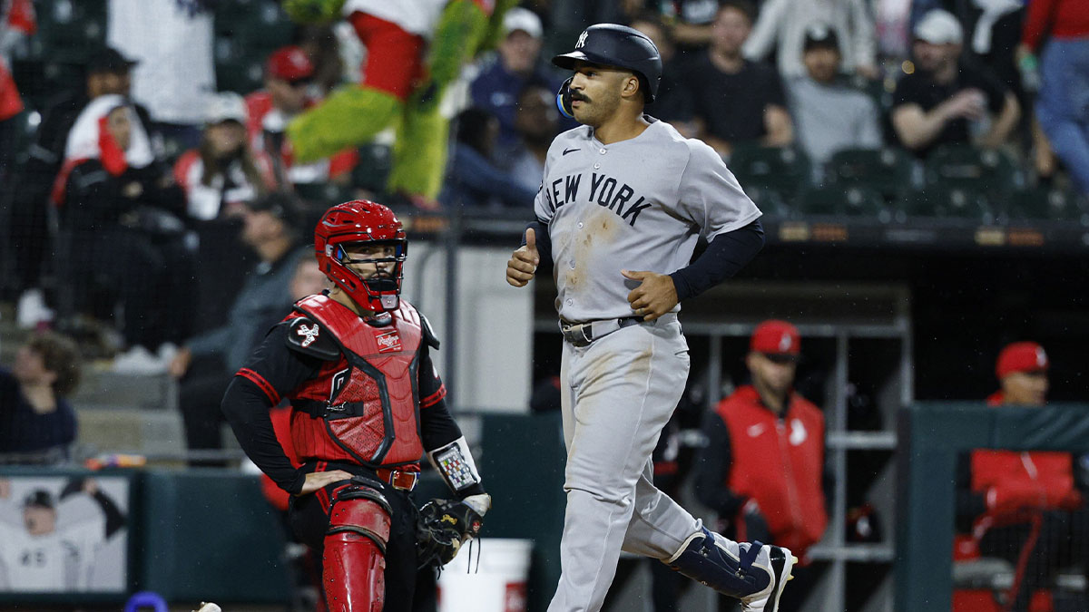New York Yankees center fielder Trent Grisham (12) crosses home plate after hitting a grand slam against the Chicago White Sox during the fourth inning at Rate Field.