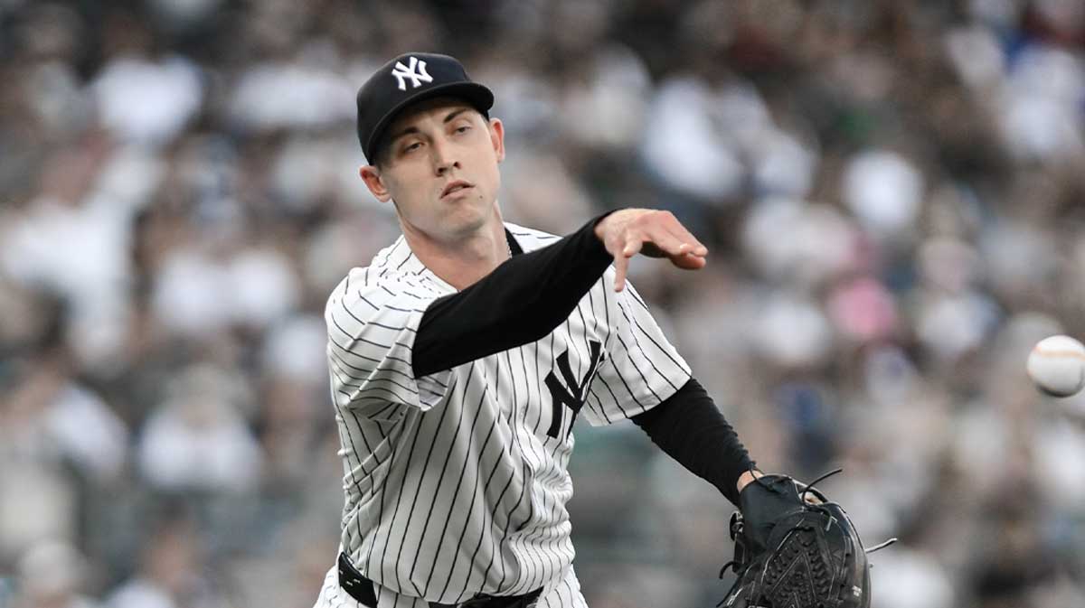 New York Yankees pitcher Luke Weaver (30) tosses the ball to first base after fielding a ground ball hit by Baltimore Orioles first baseman Coby Mayo (not pictured) during the seventh inning at Yankee Stadium.