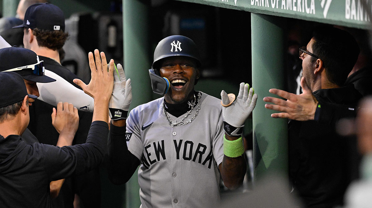 New York Yankees second baseman Jazz Chisholm Jr. (13) celebrates his one run home run in the dugout during fifth inning inning against the Boston Red Sox at Fenway Park.