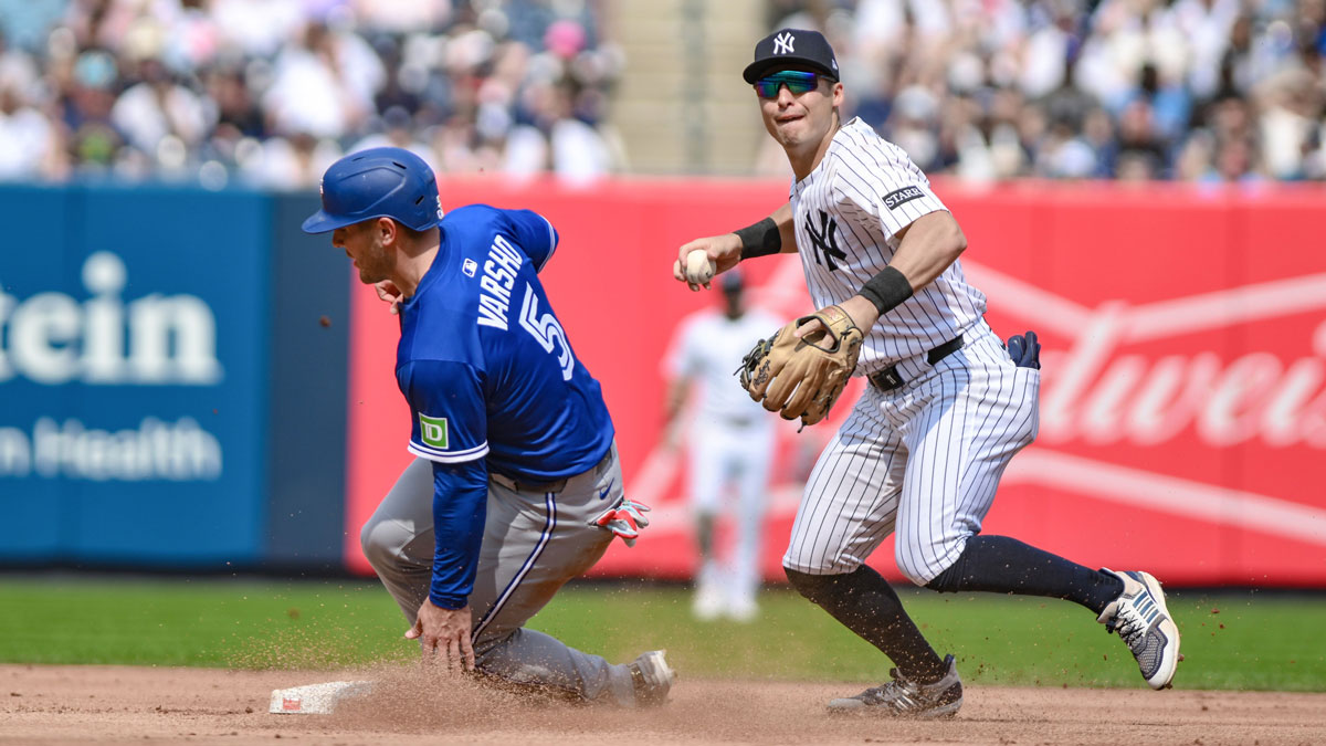 New York Yankees shortstop Anthony Volpe (11) forces out Toronto Blue Jays outfielder Daulton Varsho (5) at second base but cannot complete the double play during the fourth inning at Yankee Stadium.
