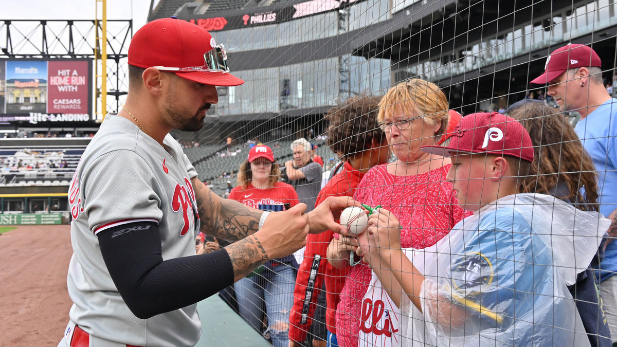 Philadelphia Phillies right fielder Nick Castellanos (8) signs autographs for fans prior to a game against the Chicago White Sox at Rate Field. 
