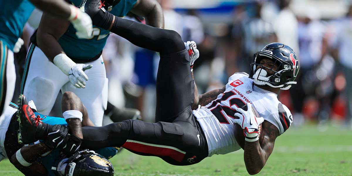 Jacksonville Jaguars cornerback Jourdan Lewis (2) tackles Houston Texans wide receiver Nico Collins (12) during the fourth quarter.