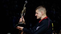Denver Nuggets center Nikola Jokic (15) gestures with the KIA NBA MVP trophy to his teammates before game five against the Minnesota Timberwolves in the second round for the 2024 NBA playoffs at Ball Arena.